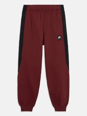 Obrázek produktu Teplákové kalhoty Nike tmavě červená
