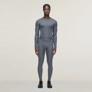 Obrázek produktu Dlouhé sportovní legíny adidas x entire studios Techfit Granite