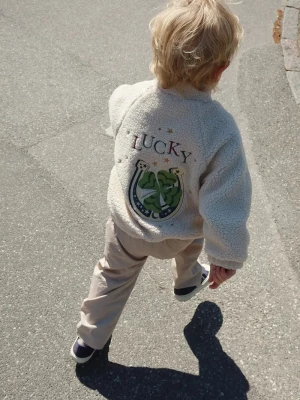 Obrázek produktu Konges Sløjd Dětská bunda JAZZ TEDDY JACKET GRS béžová