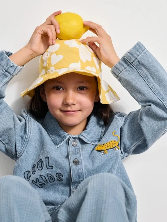 Obrázek produktu Liewood Dětský oboustranný bavlněný klobouk Liewood Amelia Reversible Sun Hat žlutá