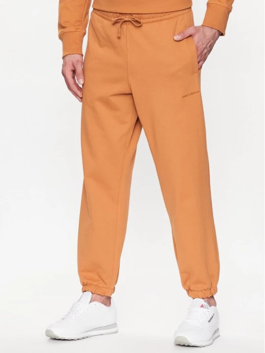 Obrázek produktu New Balance Teplákové kalhoty MP23551 Oranžová Relaxed Fit