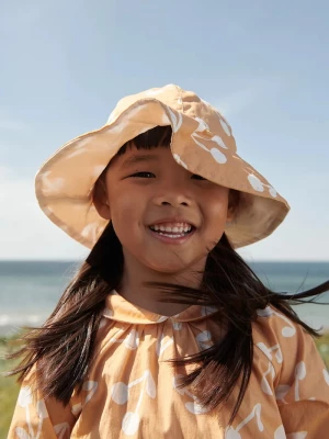 Obrázek produktu Liewood Dětský oboustranný klobouk Liewood Amelia Reversible Sun Hat oranžová